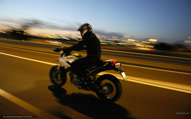motorcycle rider on highway at dusk