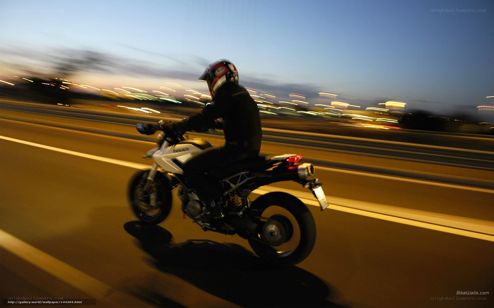 motorcycle rider on highway at dusk