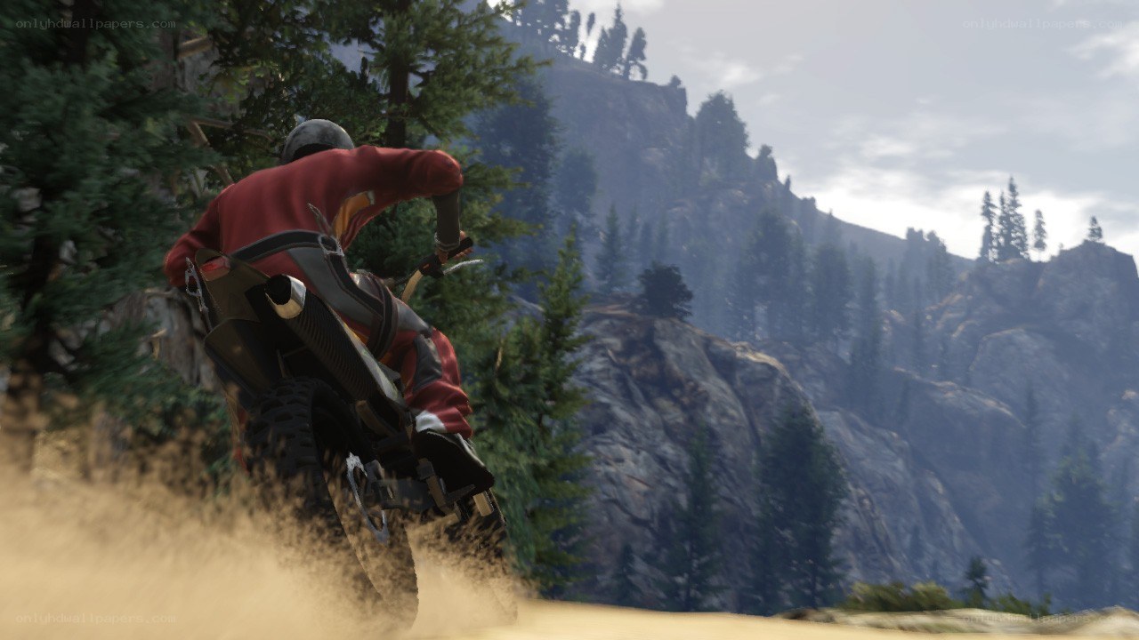 motorcycle rider on mountain trail