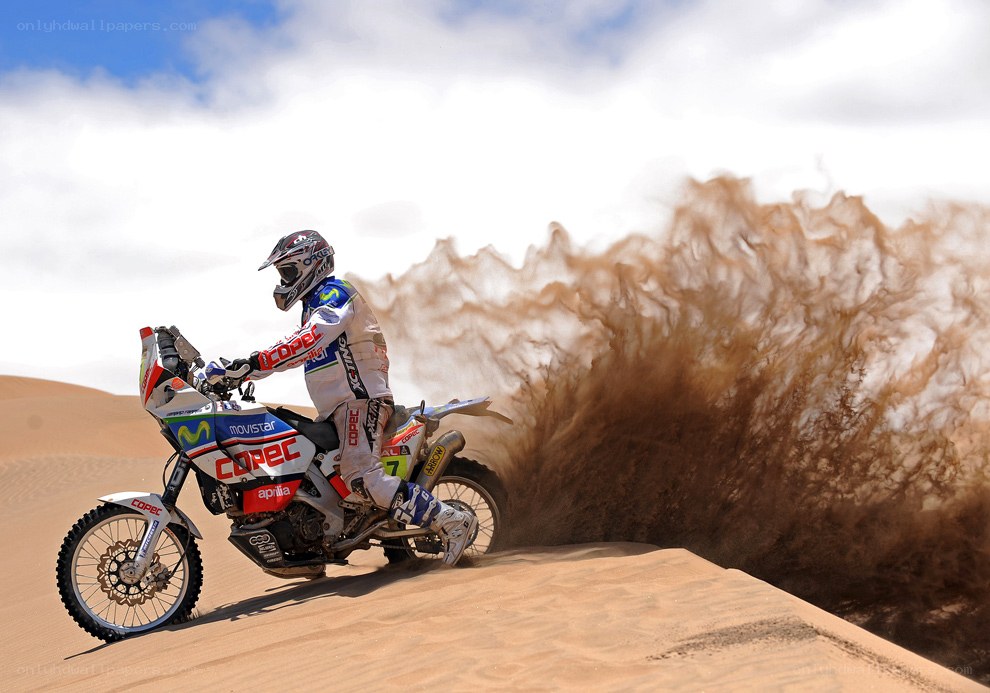 Motorcycle rider on sand dune
