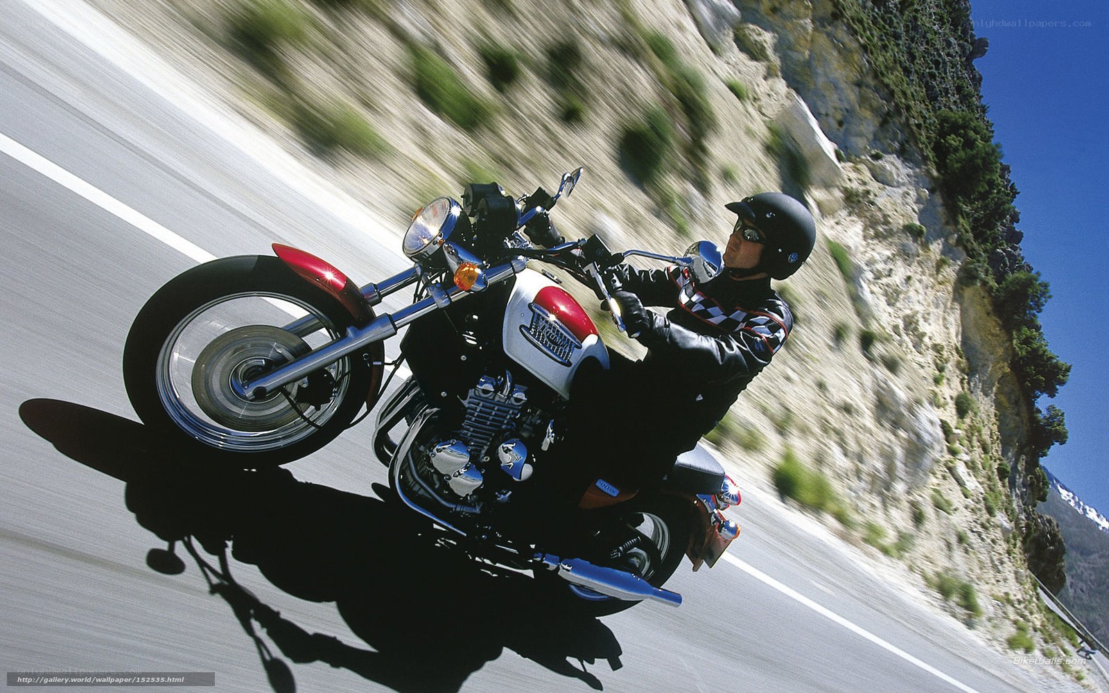 Motorcycle rider on winding road