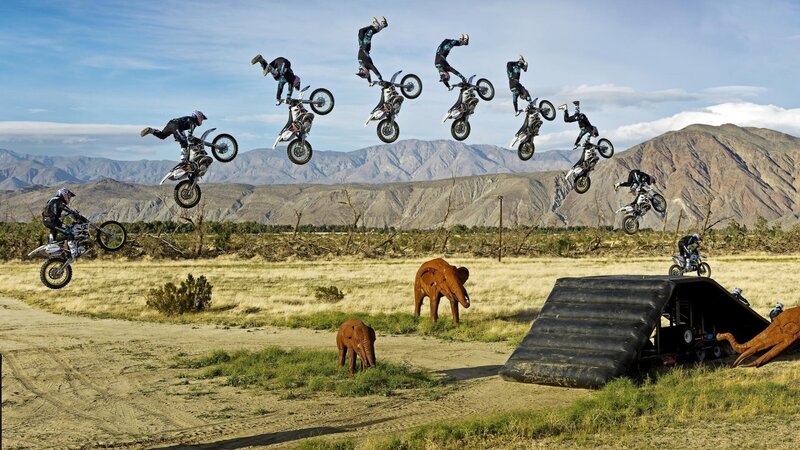 Motorcycle rider performing jump sequence