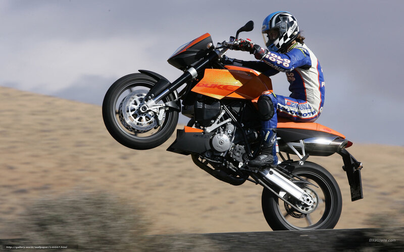 Motorcycle Rider Performing Wheelie — Orange