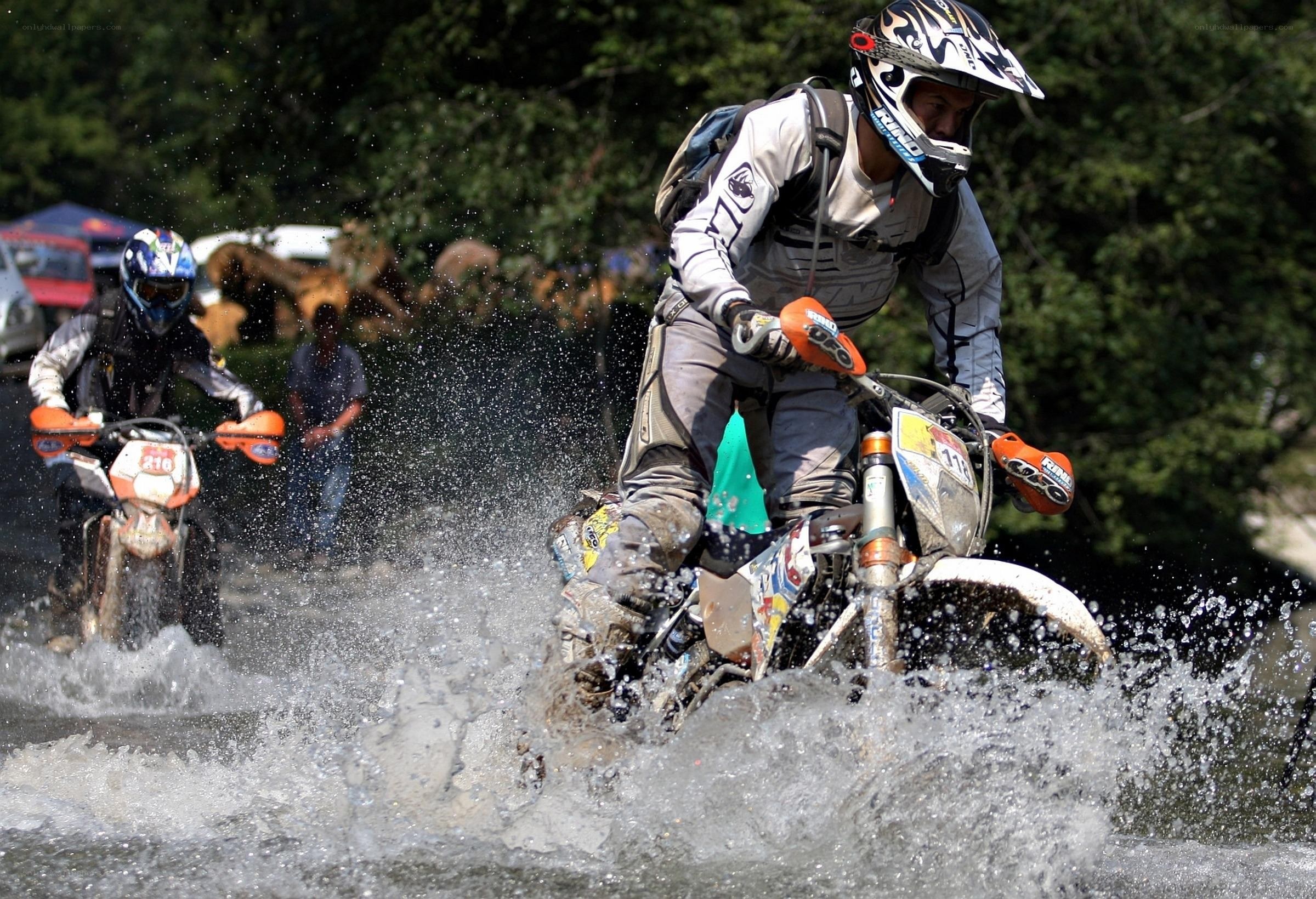Motorcycle riders crossing a river
