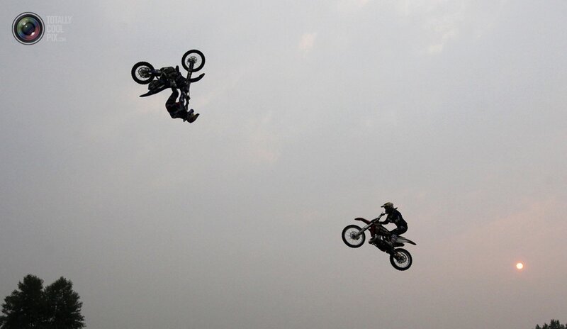 Motorcycle Riders in Mid-air — Gray
