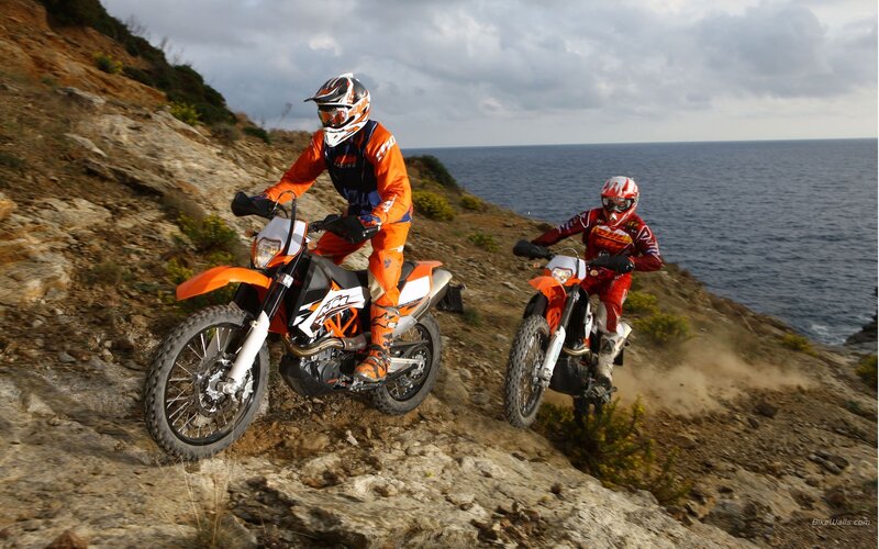 Motorcycle riders on coastal trail