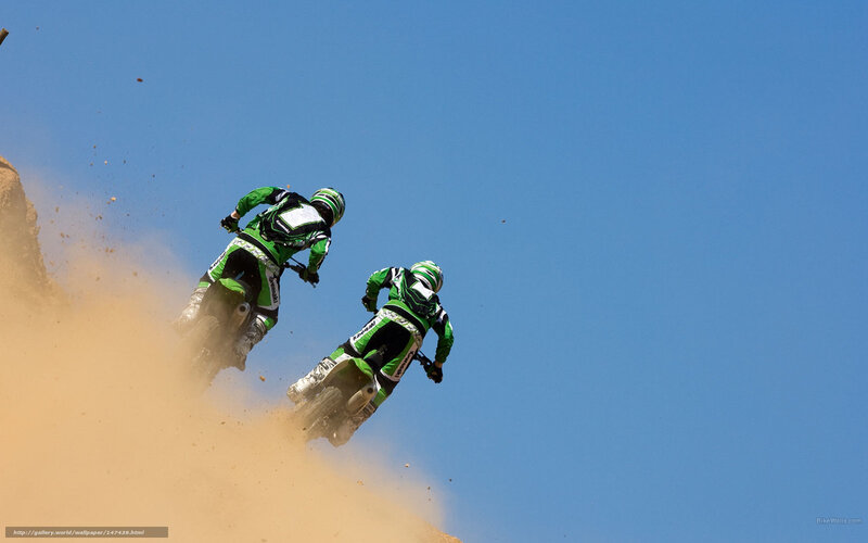 Motorcycle riders on dusty hill