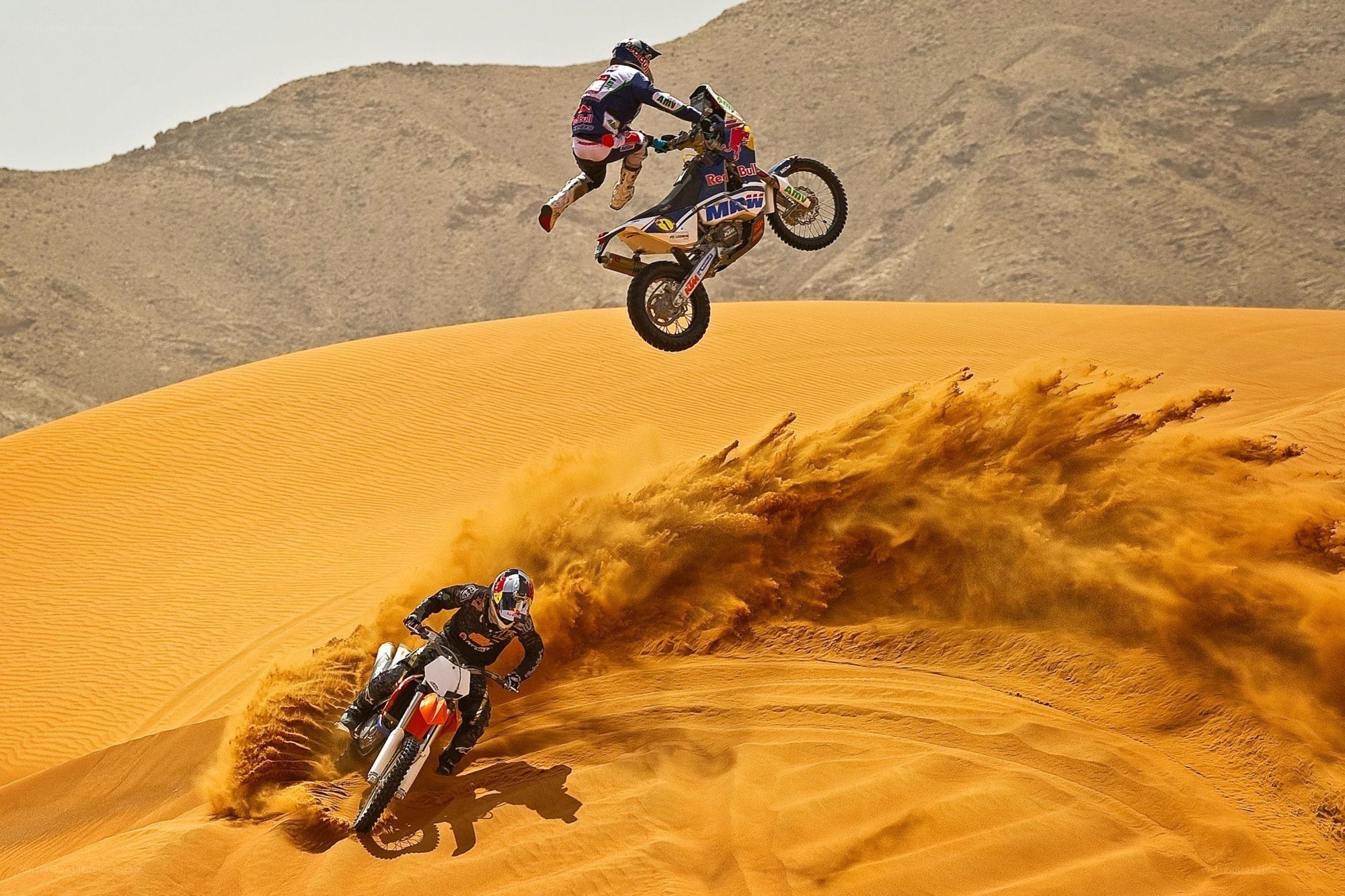 Motorcycle riders on sand dunes