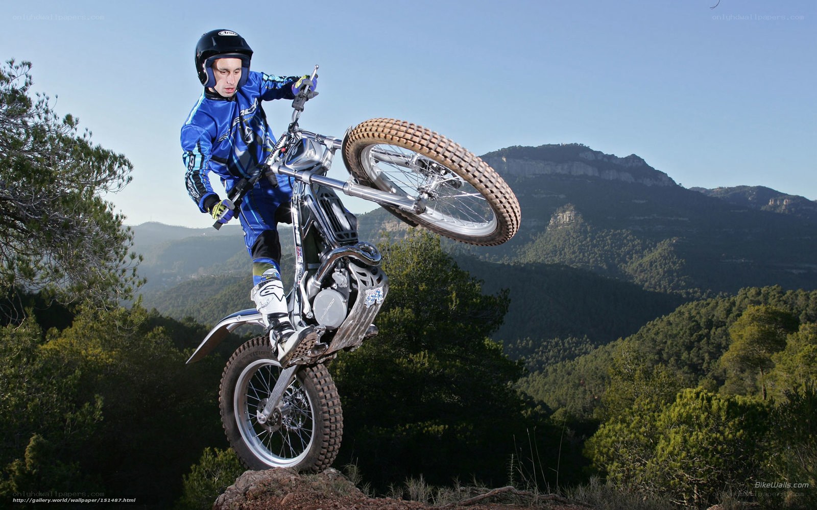 motorcycle stunt on mountain trail