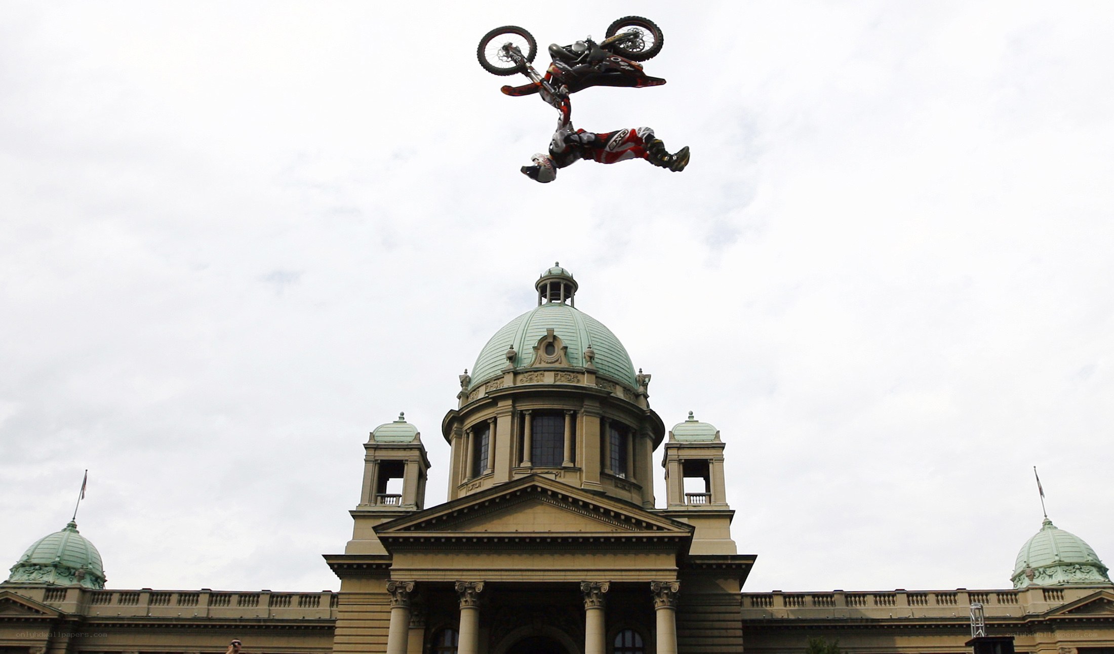 Motorcycle stunt over historic building