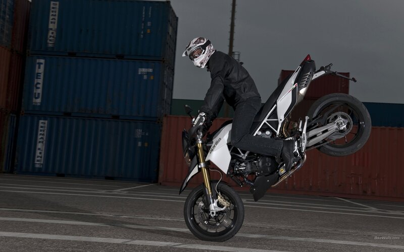 motorcycle wheelie in shipping yard