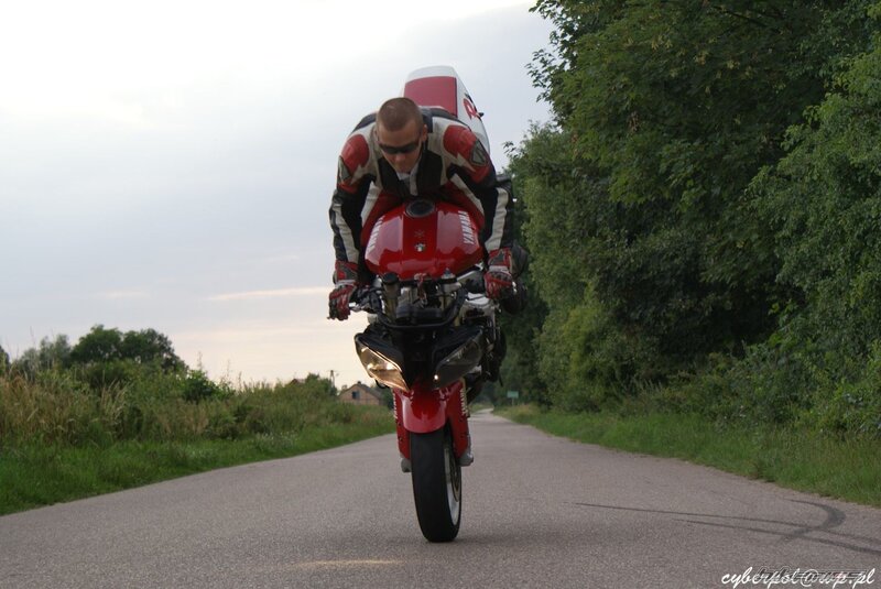 Motorcycle wheelie on country road