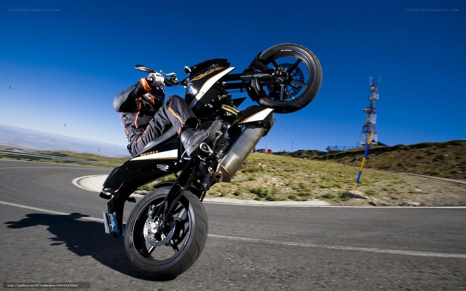 motorcycle wheelie on mountain road
