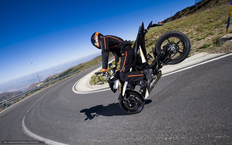 motorcycle wheelie on mountain road