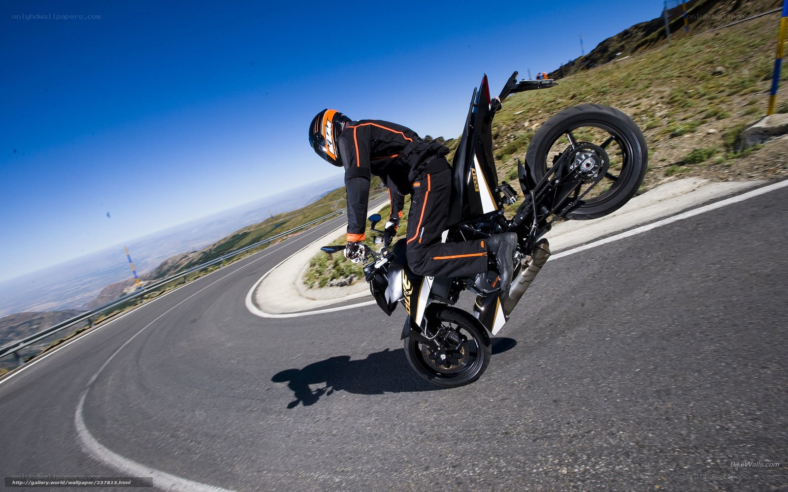 motorcycle wheelie on mountain road