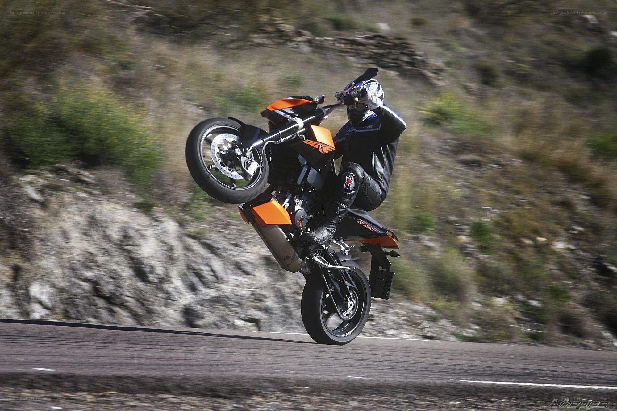 motorcycle wheelie on road