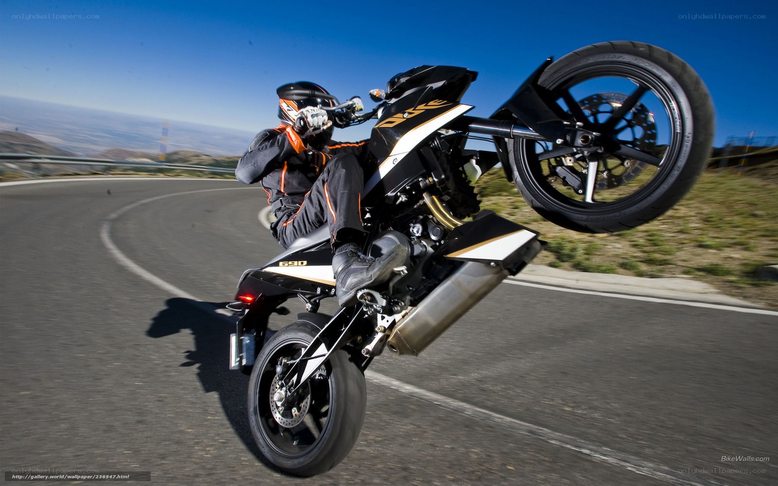 Motorcycle wheelie on winding road