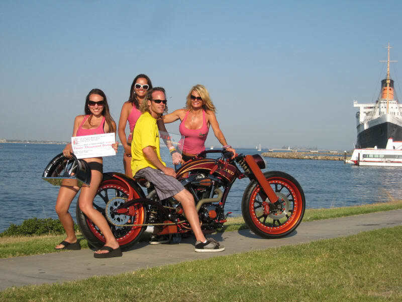 Motorcycle with models by the water