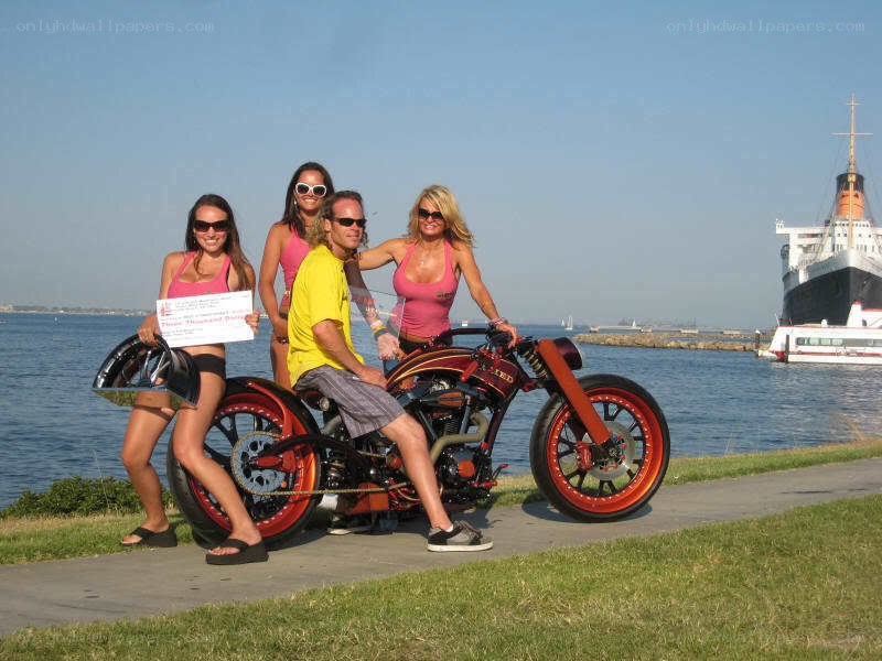 Motorcycle with models by the water