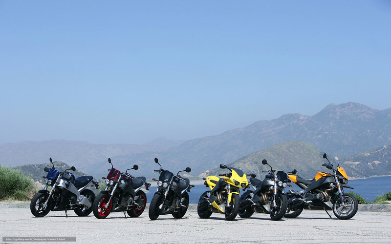 motorcycles lined up on a scenic overlook