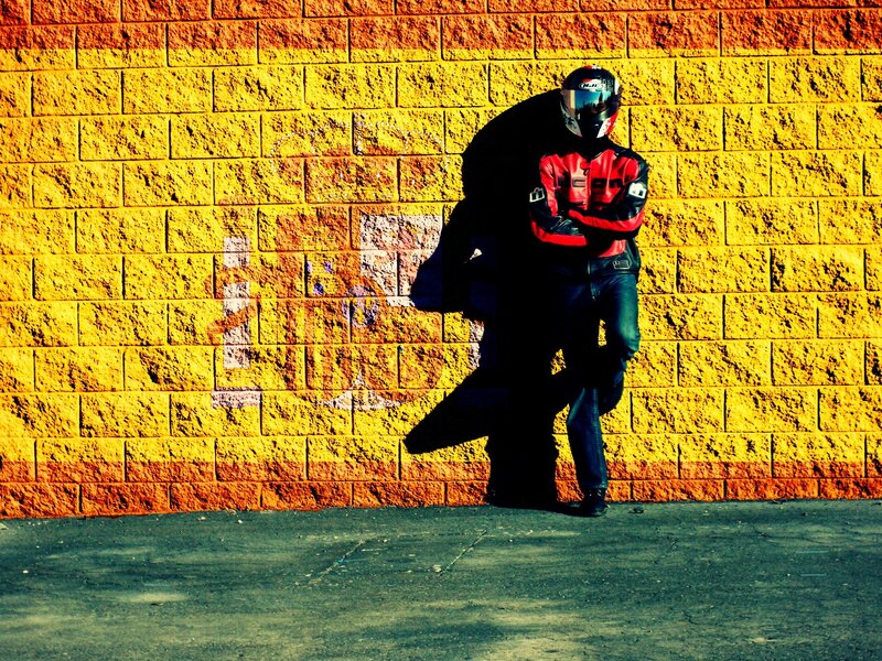 Motorcyclist against a colorful wall