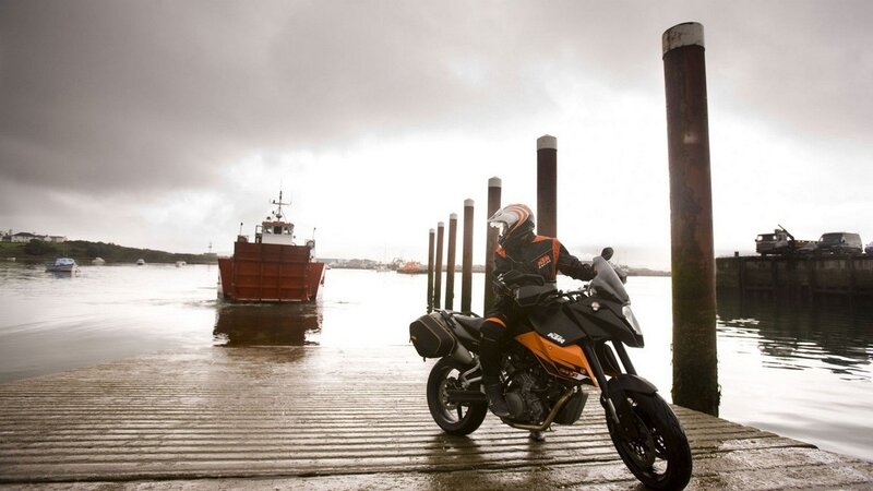 Motorcyclist at a dock with boat