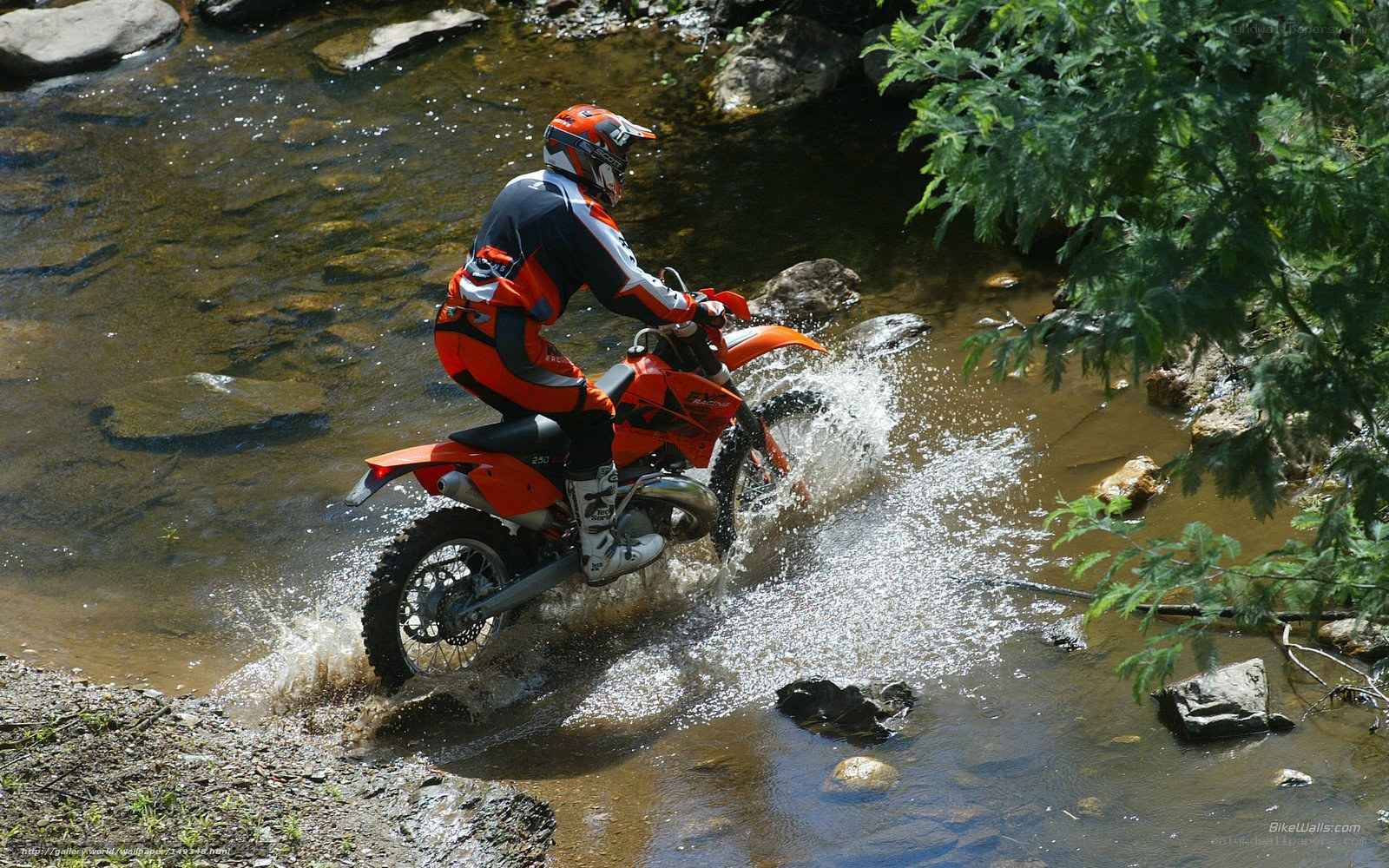 Motorcyclist crossing a stream