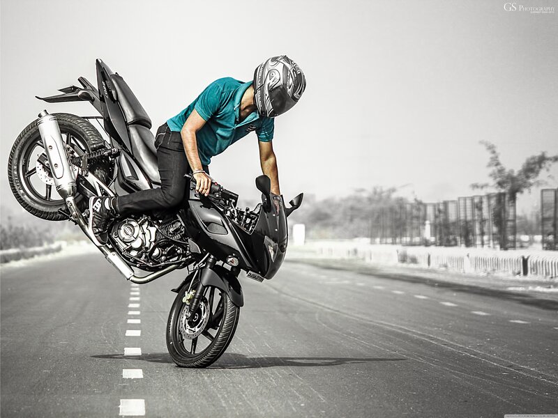 Motorcyclist Doing Wheelie — Black, Dramatic, Afternoon, Photograph, Road, Helmet, Bicycle