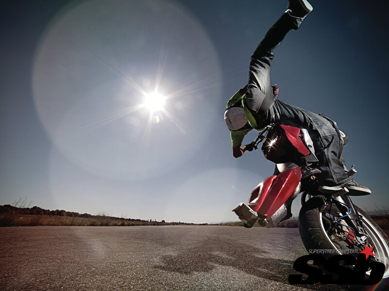 Motorcyclist Doing Wheelie — Red
