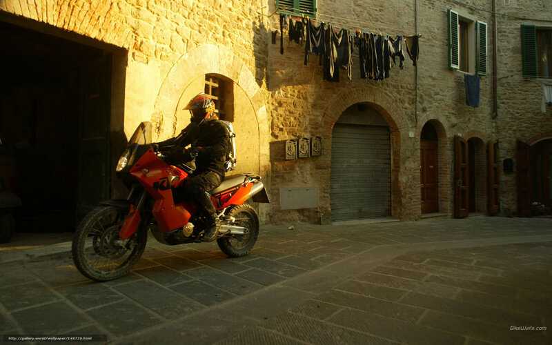 Motorcyclist in a sunlit alley