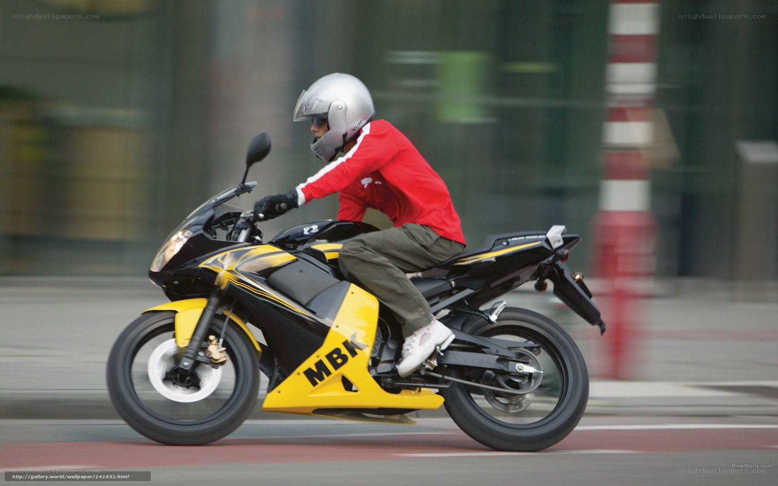 Motorcyclist in red on city street