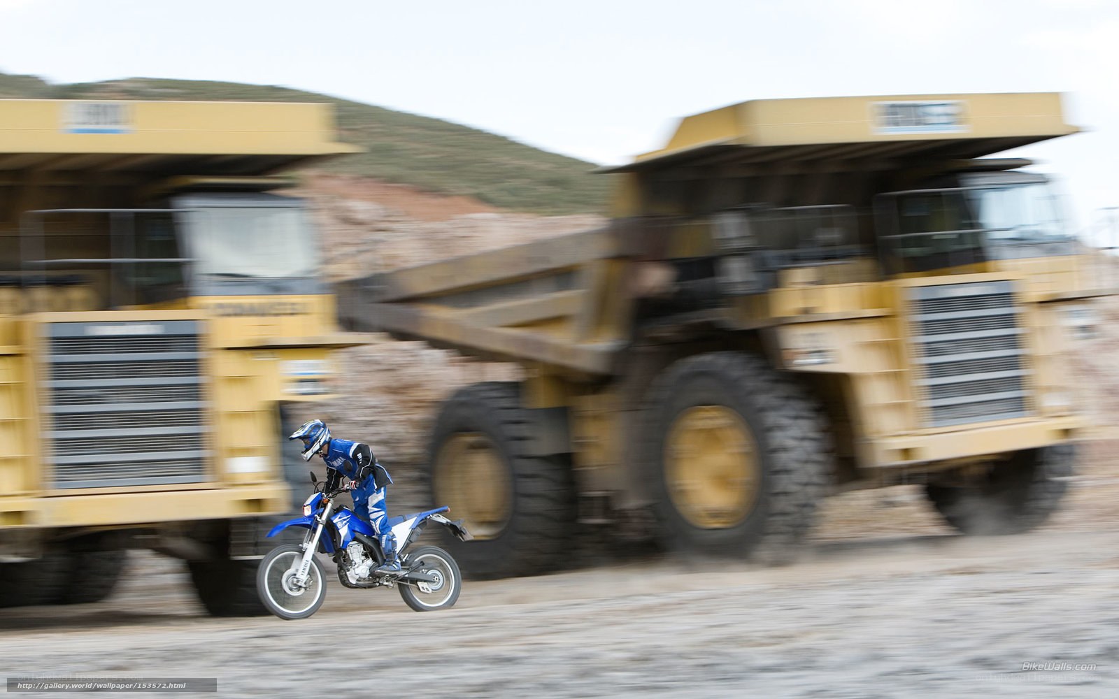 Motorcyclist near dump trucks