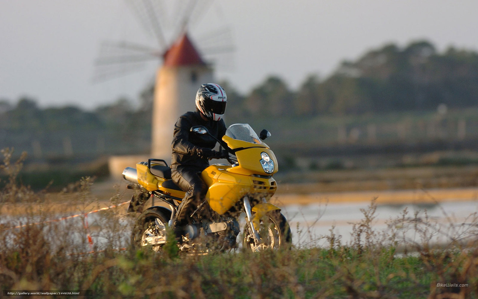Motorcyclist near windmill