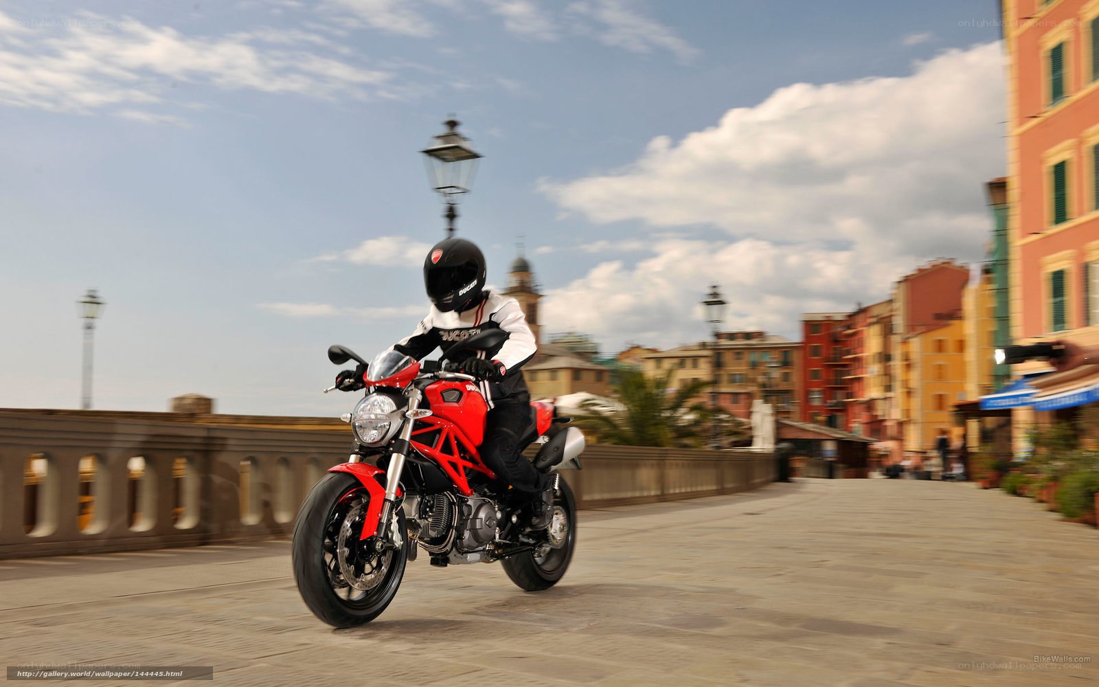Motorcyclist on a city bridge