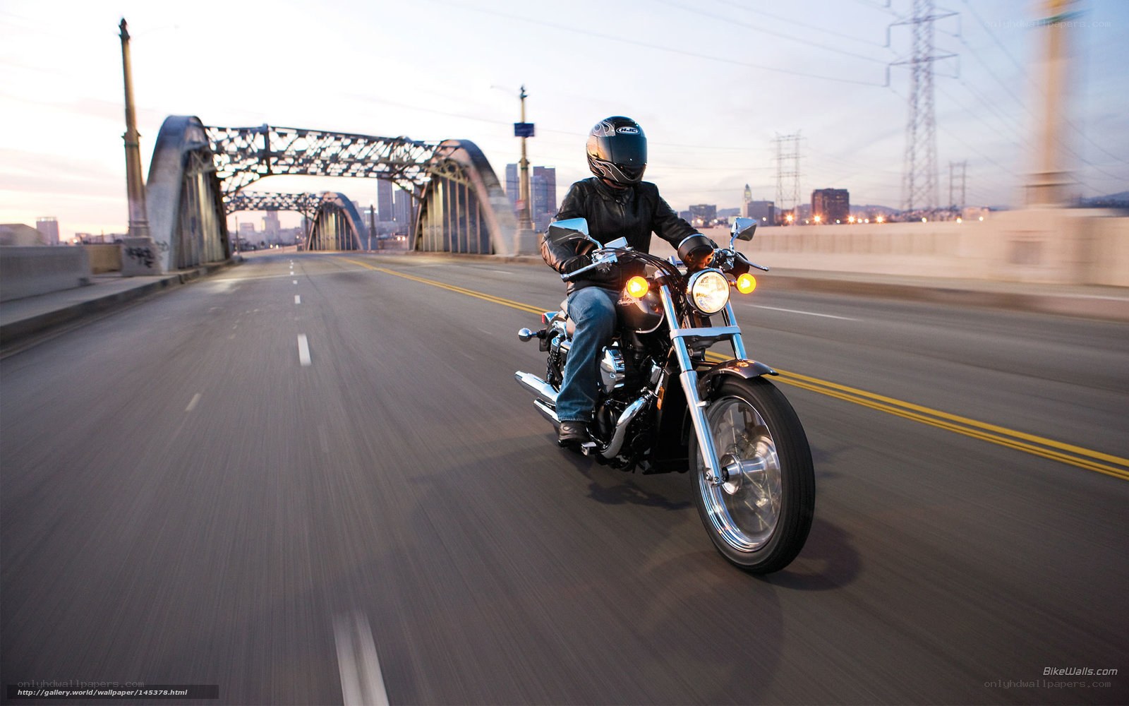 Motorcyclist on a city bridge