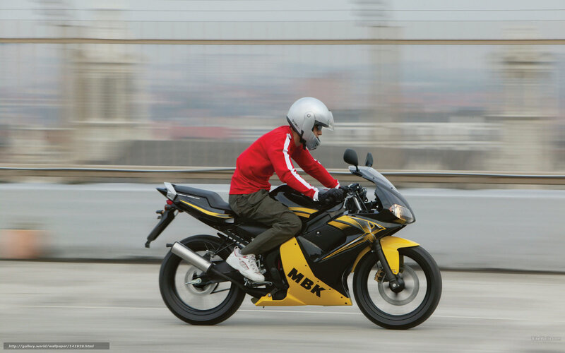 Motorcyclist on a city bridge