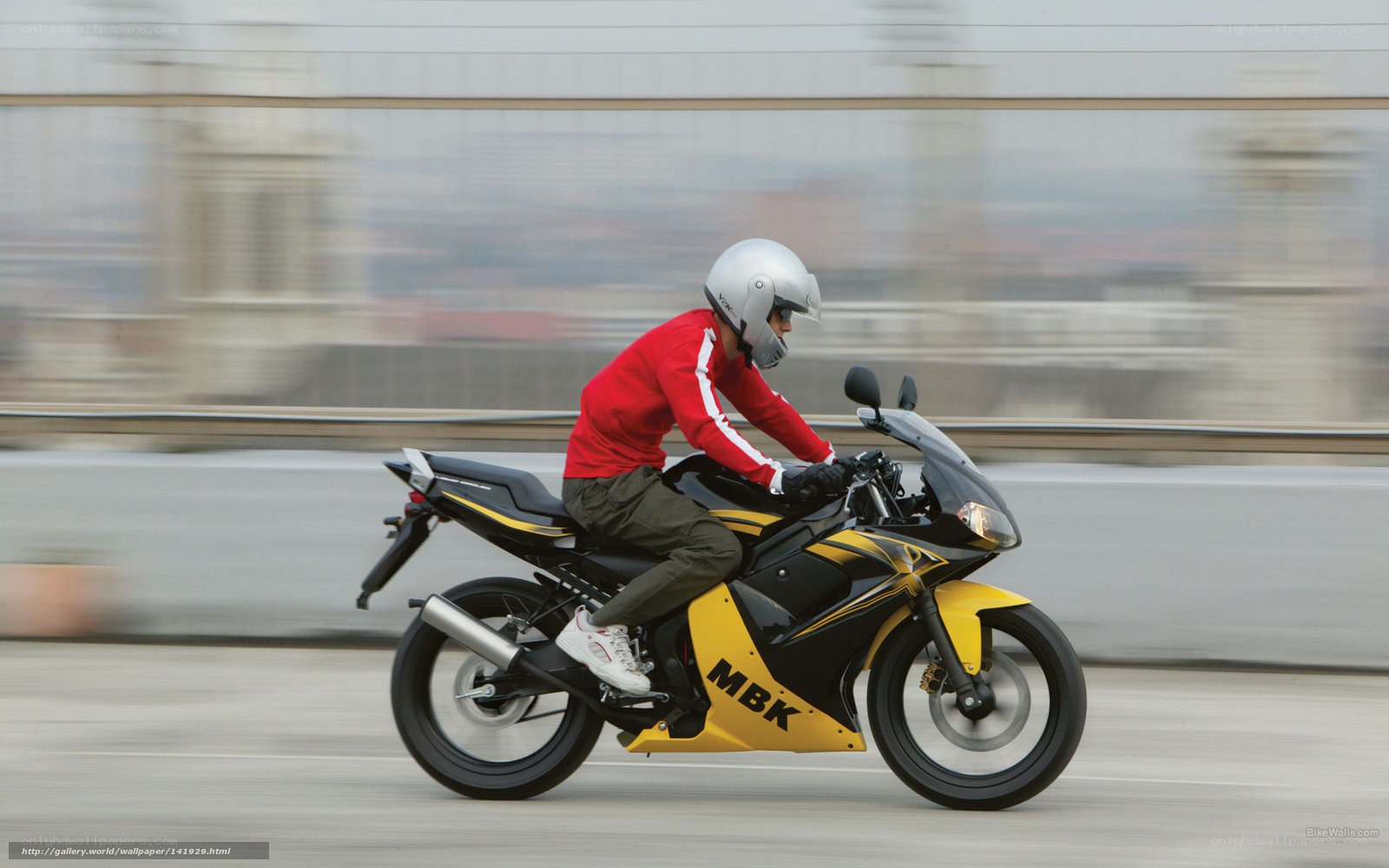 Motorcyclist on a city bridge