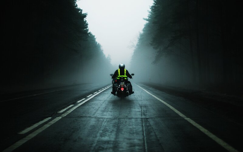 Motorcyclist on a foggy road