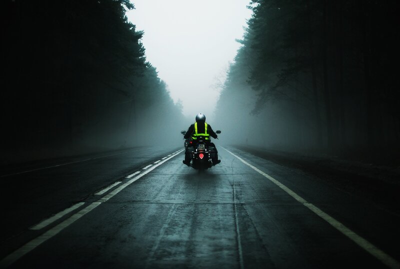 Motorcyclist on a foggy road