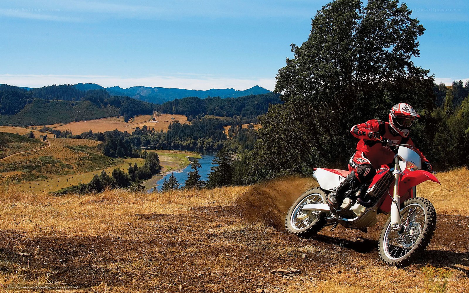 Motorcyclist on a hillside trail