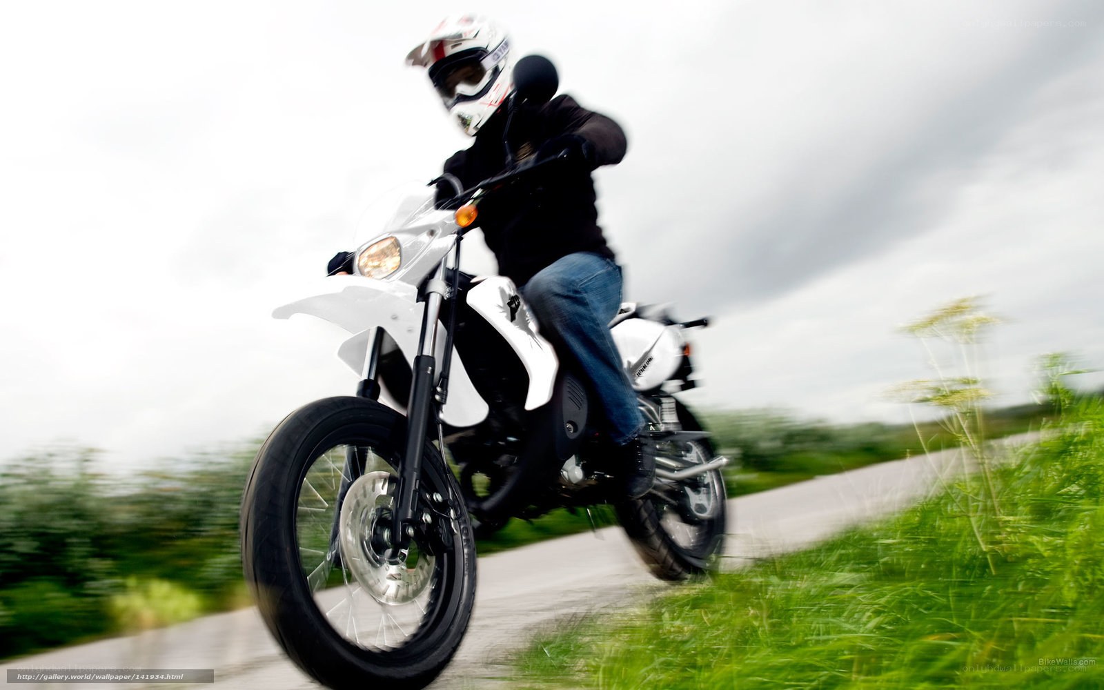 motorcyclist on a white bike