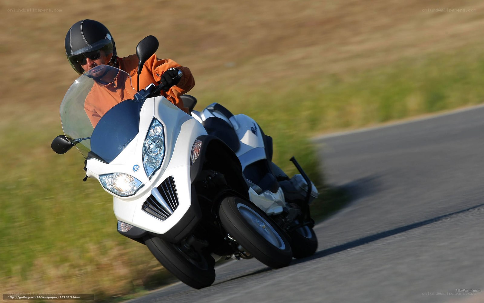 motorcyclist on a white scooter