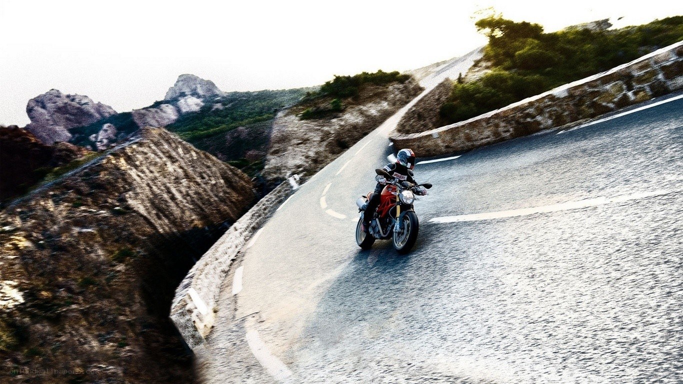Motorcyclist on a winding mountain road