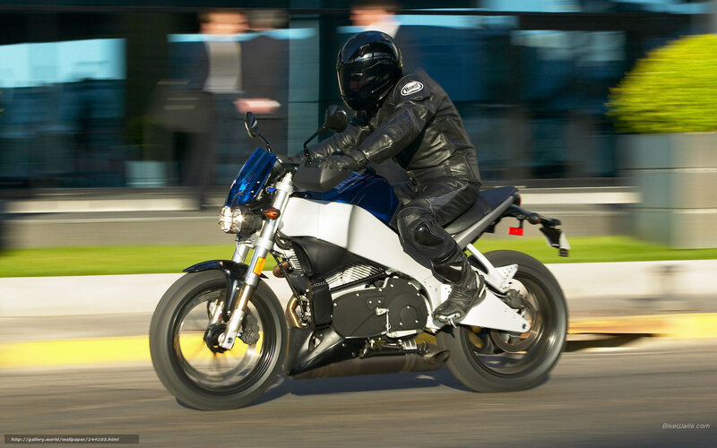 Motorcyclist on Blue and White Bike