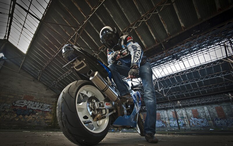 Motorcyclist on Blue Bike — Dramatic