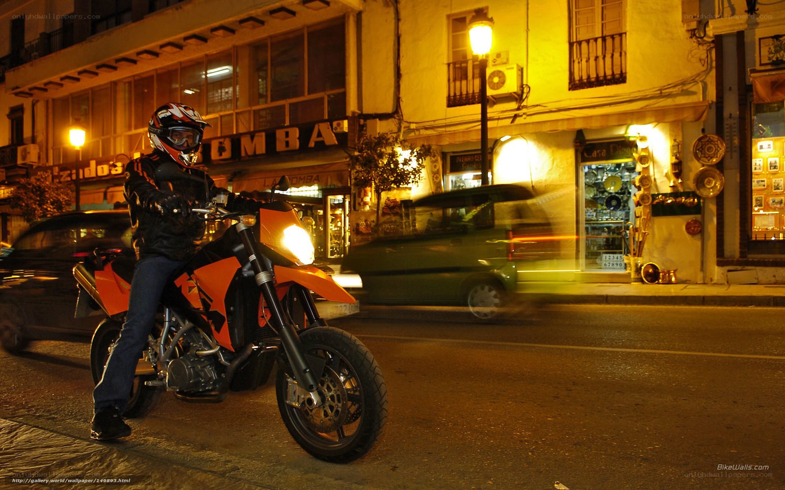 Motorcyclist on city street at night
