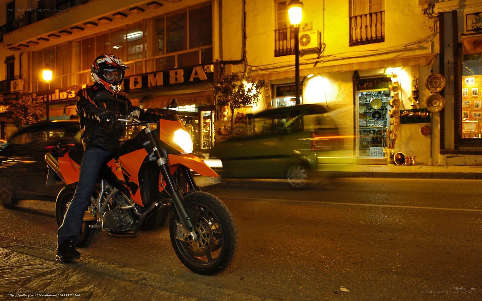 Motorcyclist on city street at night
