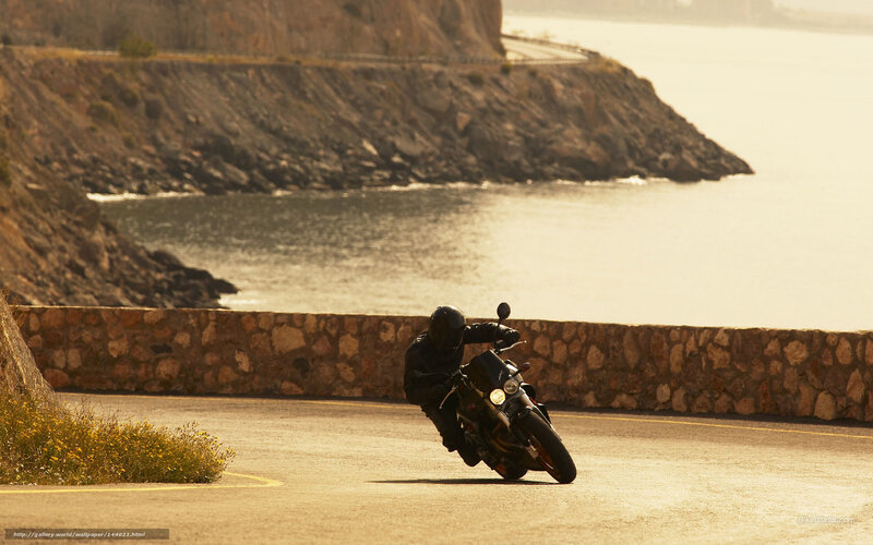 Motorcyclist on Coastal Road — Brown