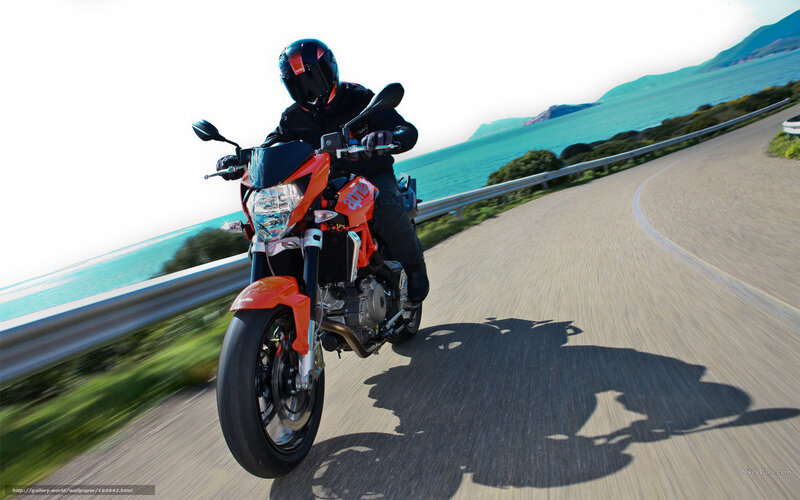 Motorcyclist on Coastal Road — Orange