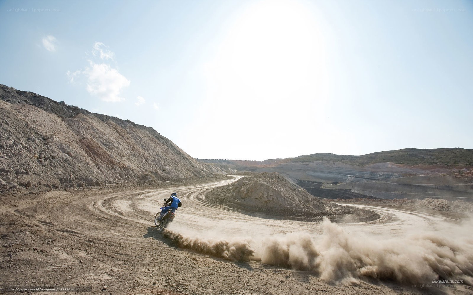 Motorcyclist on dusty trail